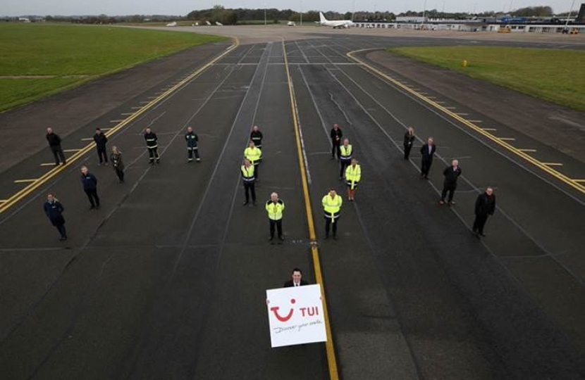 Tees Valley Mayor Ben Houchen and airport staff on the runway revealing the TUI announcement
