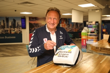 Neil Warnock at Teesside International Airport cutting the cake for the launch of the Cornwall Airport Newquay route
